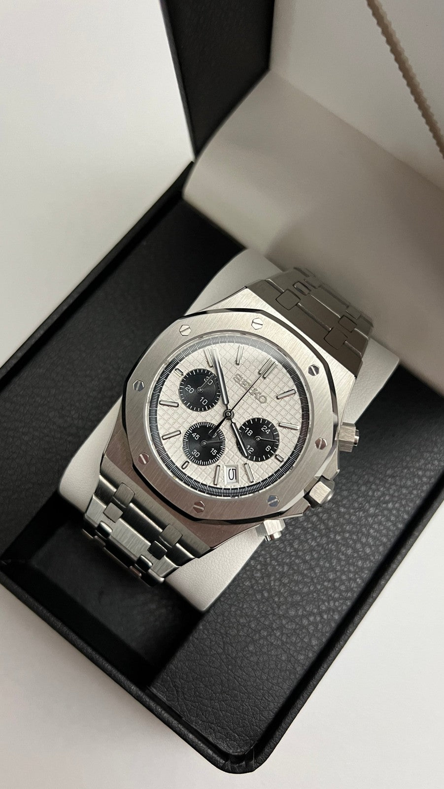 Royal Oak Chrono (Panda) Seiko VK63 meca-quartz chronograph mod watch. An angled shot of a watch with a white dial and black subdials resting inside a black display box.