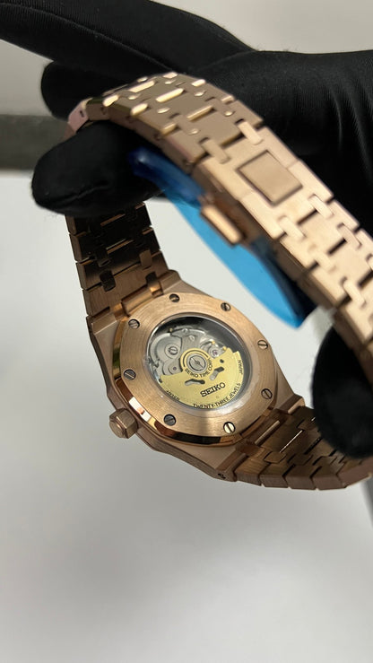 Royal Oak (Rose Gold) Seiko NH35 automatic mod watch. A caseback detail shows the exposed mechanical movement of the rose gold watch held by a gloved hand.