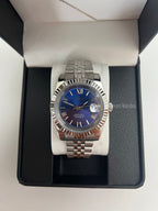 Datejust (Royal Blue Roman) Seiko NH35 automatic mod watch. A blue dial watch with a silver fluted bezel and jubilee bracelet shown in a box from a front view.