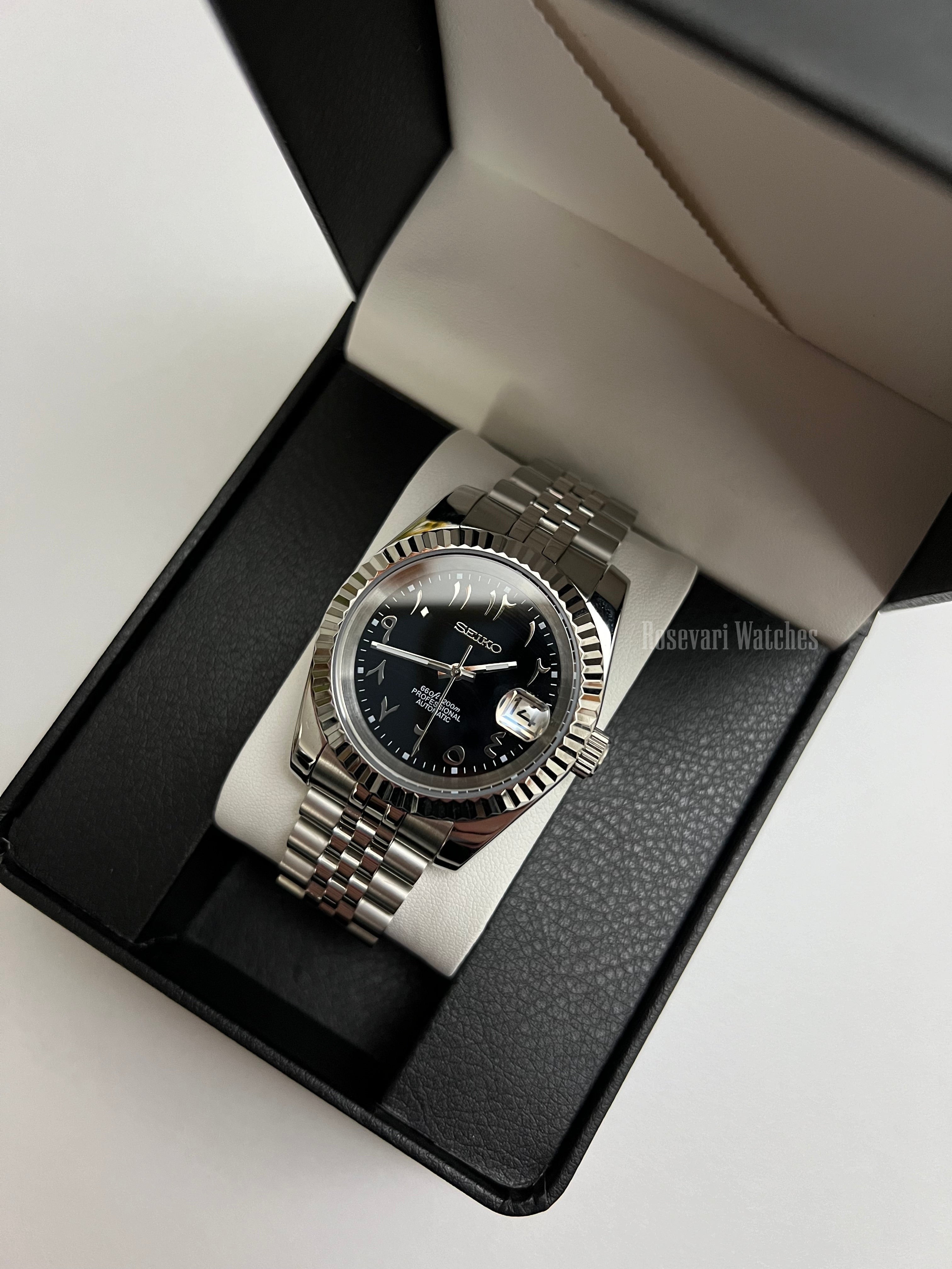 Datejust (Arabic Black) Seiko NH35 automatic mod watch. A black dial watch with a silver fluted bezel and a metal jubilee bracelet inside an open gift box.