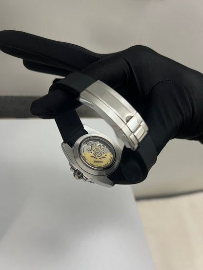 Yacht-Master (Grey) Seiko NH35 automatic mod watch. A caseback detail showing the mechanical movement of the watch held by a gloved hand.