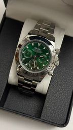 Daytona (Green) Seiko VK63 meca-quartz chronograph mod watch. A green dial watch with a silver bezel and metal link bracelet inside an open black display box.