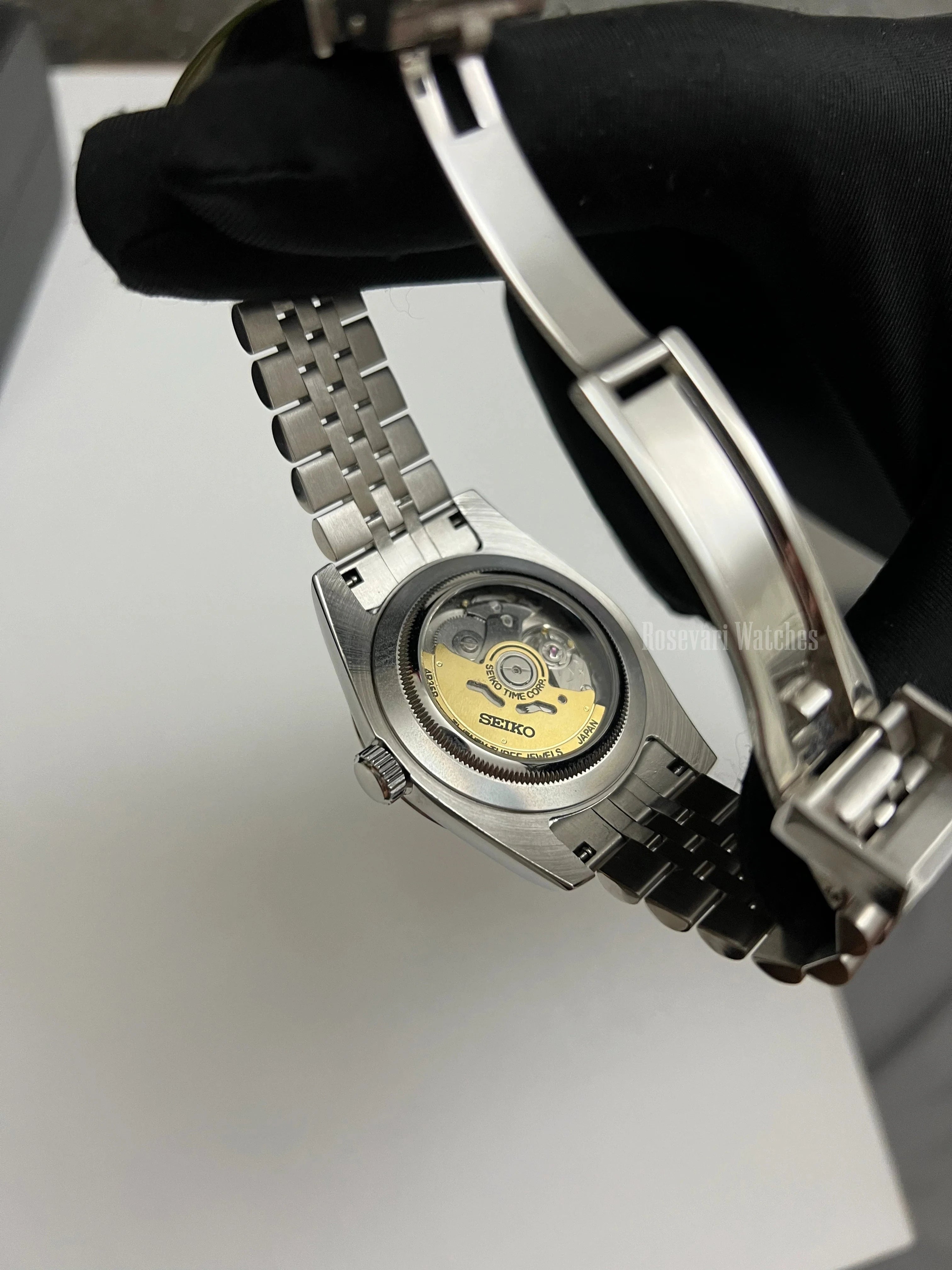 Datejust (Arabic White) Seiko NH35 automatic mod watch. A view of the watch caseback showing the mechanical movement and the jubilee bracelet.