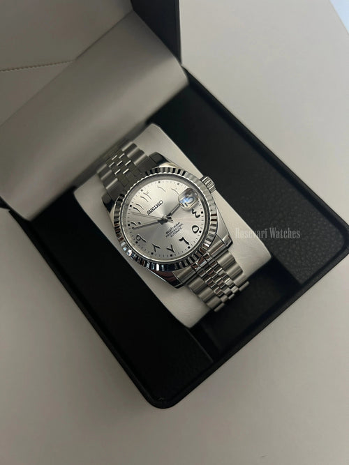 Datejust (Arabic White) Seiko NH35 automatic mod watch. A silver dial watch with a fluted bezel and jubilee bracelet inside an open watch box.