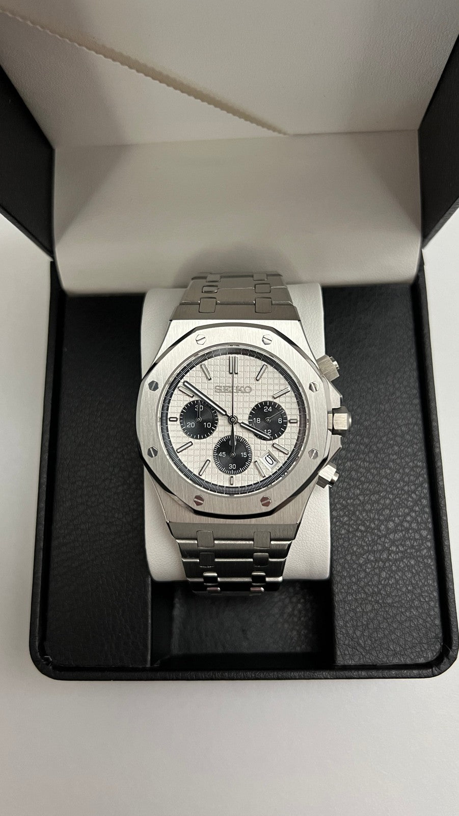 Royal Oak Chrono (Panda) Seiko VK63 meca-quartz chronograph mod watch. A centered shot of a watch with a white dial and black subdials resting inside a black display box.