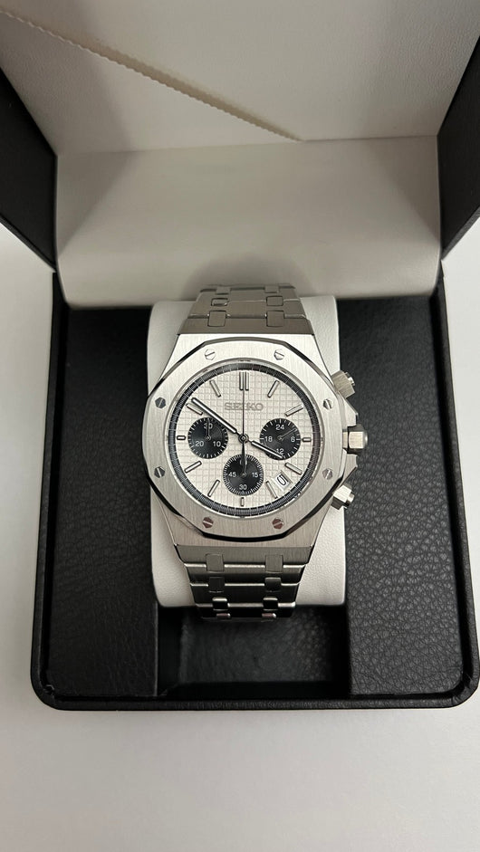 Royal Oak Chrono (Panda) Seiko VK63 meca-quartz chronograph mod watch. A centered shot of a watch with a white dial and black subdials resting inside a black display box.