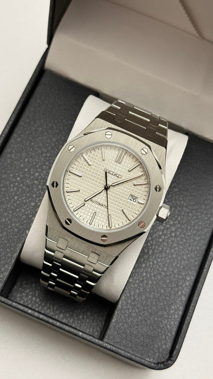 Royal Oak (White) Seiko NH35 automatic mod watch. A silver dial watch with a silver bezel and integrated metal bracelet shown in a full angled view.