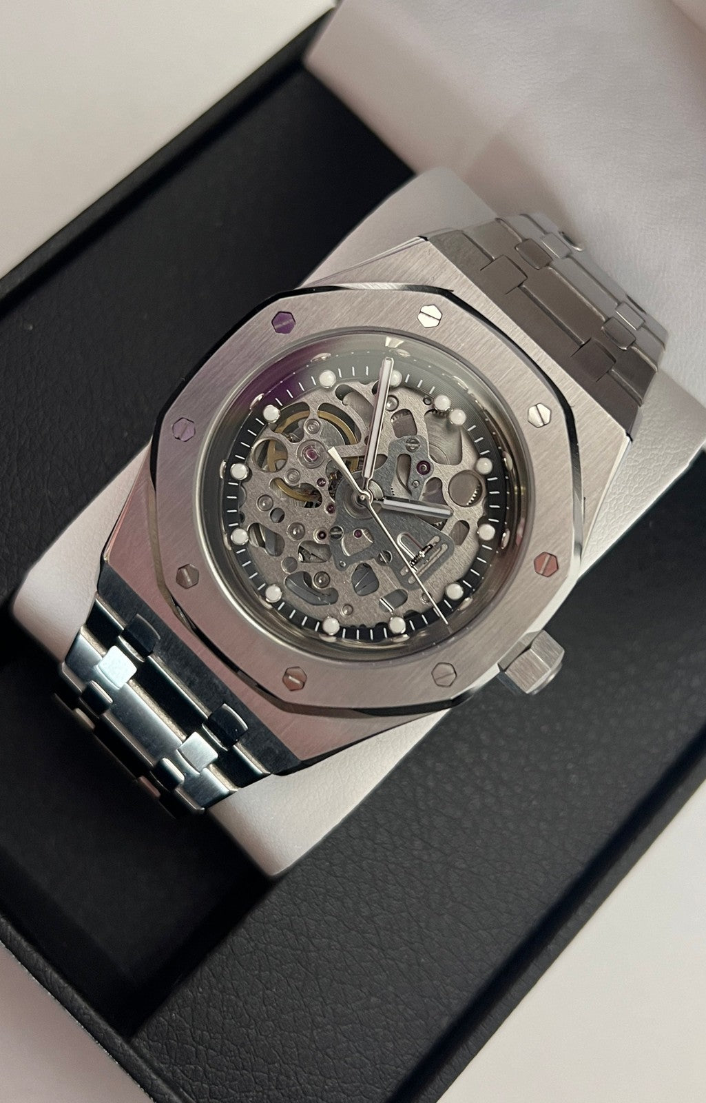 Royal Oak (Skeleton) Seiko NH70 skeleton automatic mod watch. A full watch shot shows a silver skeleton dial with a silver bezel and a silver metal link bracelet.