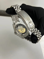 Datejust (Wimbledon Grey) Seiko NH35 automatic mod watch. A caseback detail showing the mechanical movement with a gold rotor and a silver jubilee bracelet.