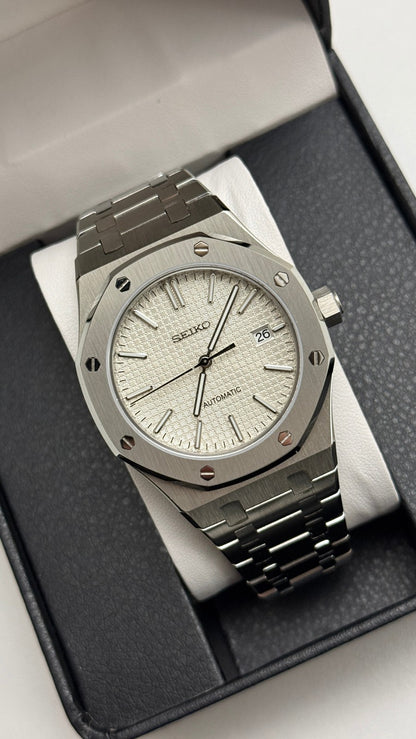 Royal Oak (White) Seiko NH35 automatic mod watch. A silver dial watch with a silver bezel and integrated metal bracelet shown in a full angled shot.