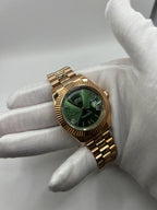 Day-Date (Rose Gold, Green) Japanese automatic mod watch. A wrist shot shows a gloved hand holding the rose gold watch with a green dial and metal link bracelet.