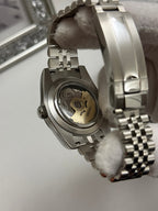 Datejust (Purple) Seiko NH35 automatic mod watch. A caseback detail shot showing the internal mechanical movement and the silver jubilee bracelet.