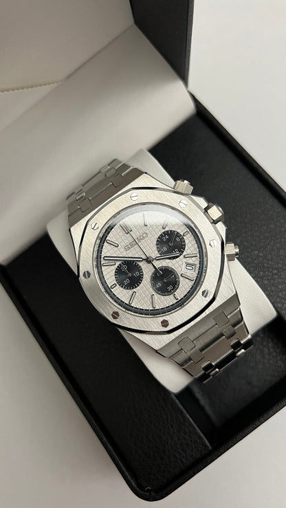 Royal Oak Chrono (Panda) Seiko VK63 meca-quartz chronograph mod watch. A high angle shot of a watch with a white dial and black subdials inside a black display box.