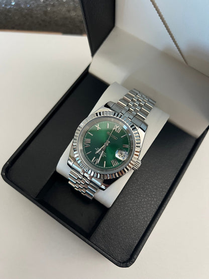 Datejust (Green Roman) Seiko NH35 automatic mod watch. A watch in a box shows a green dial with a silver fluted bezel and a silver jubilee bracelet.