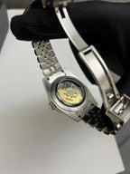 GMT (Sprite) Seiko NH34 GMT automatic mod watch. A caseback detail showing the mechanical movement of the watch with a gold rotor.