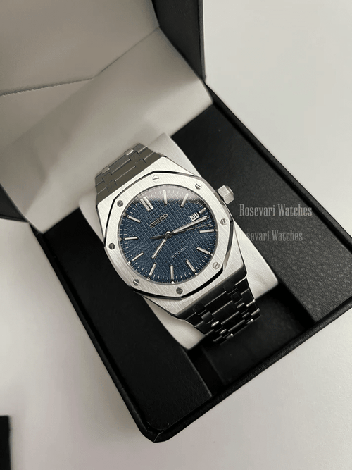 Royal Oak (Blue) Seiko NH35 automatic mod watch. A full watch shot inside a box showing a blue textured dial and silver bezel on a metal link bracelet.