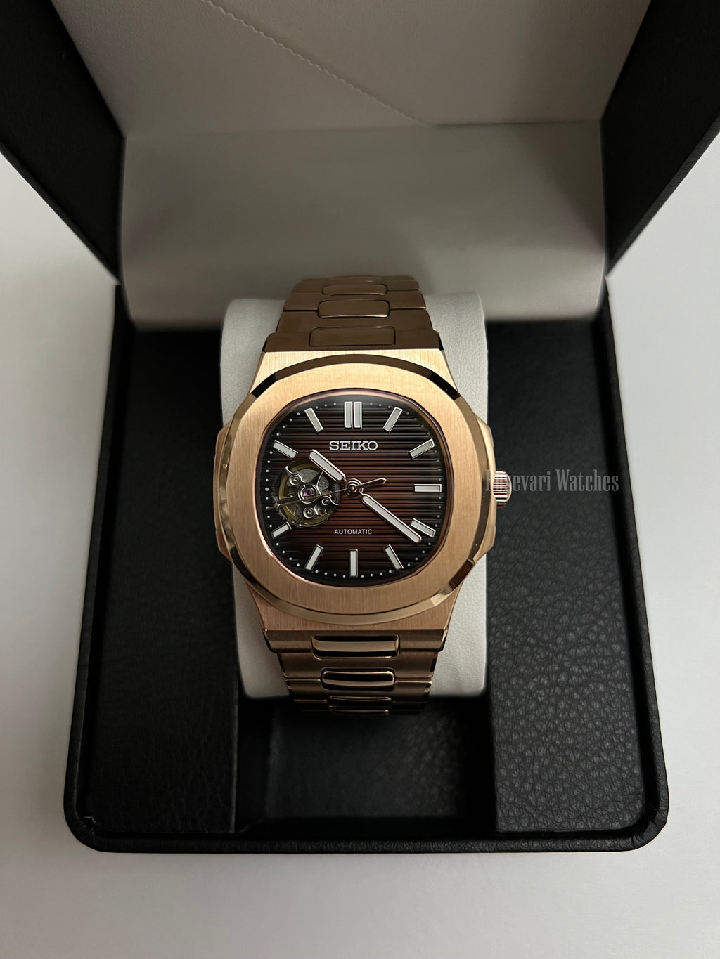 Nautilus (Open Heart, Chocolate) Seiko NH38 open-heart automatic mod watch. A full watch shot inside a box showing a brown dial with an open heart and a rose gold bracelet.