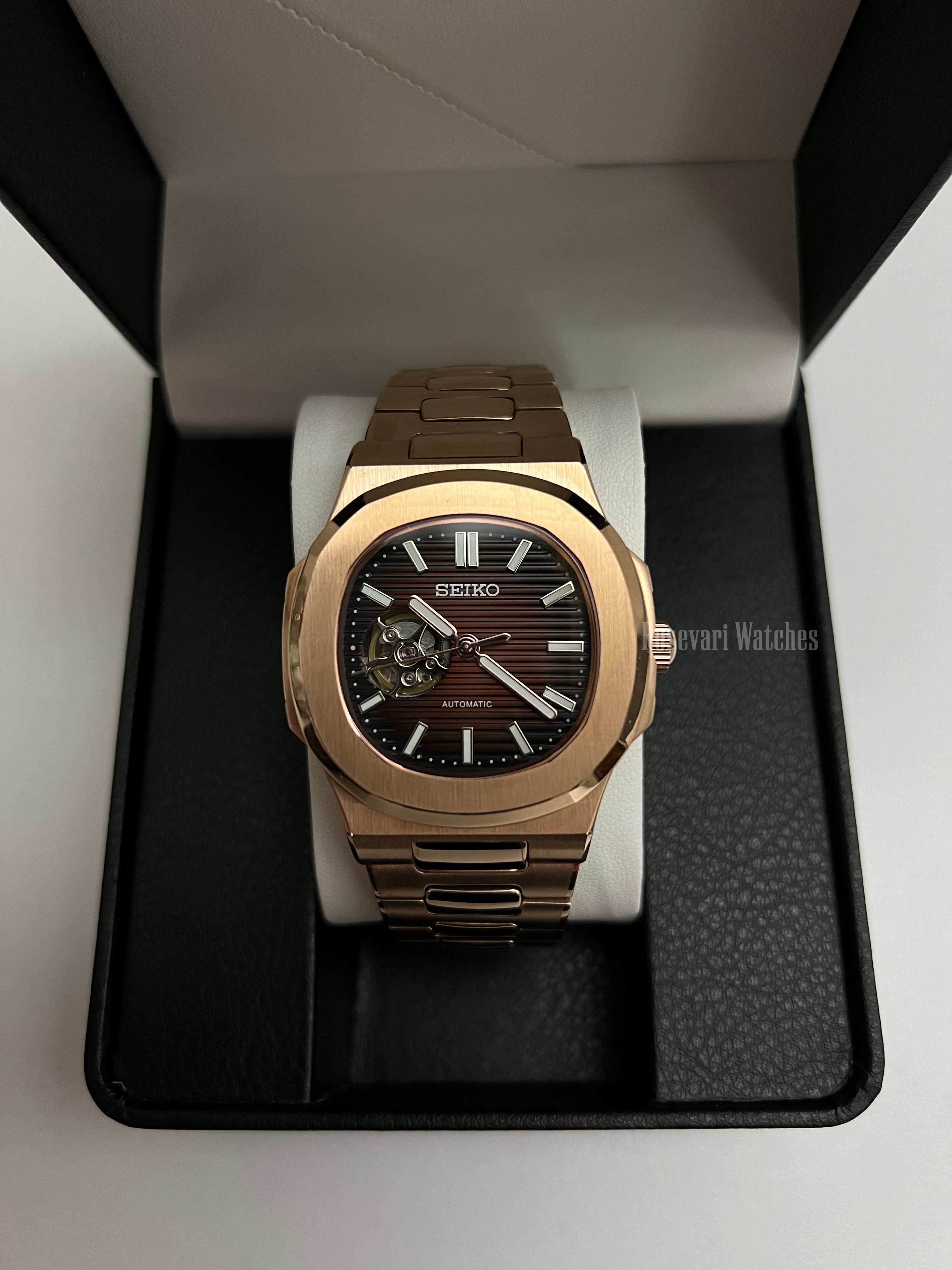 Nautilus (Open Heart, Chocolate) Seiko NH38 open-heart automatic mod watch. A full watch shot inside a box showing a brown dial with an open heart and a rose gold bracelet.