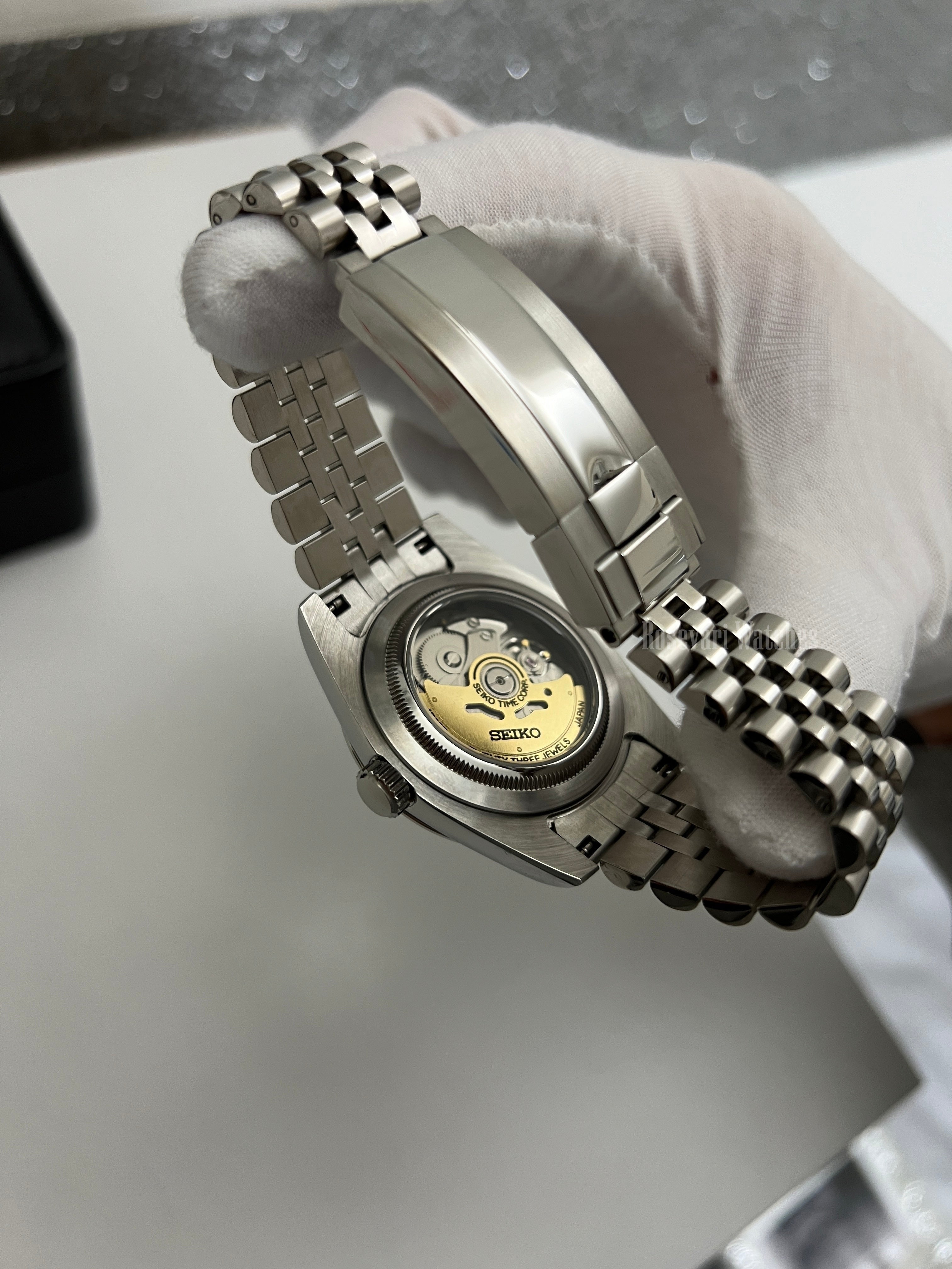 Datejust (Arabic Royal Blue) Seiko NH35 automatic mod watch. A close up of the watch caseback showing the mechanical movement and the jubilee bracelet clasp.
