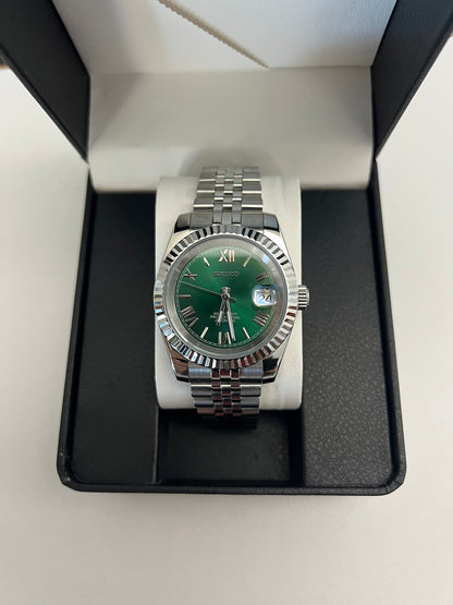 Datejust (Green Roman) Seiko NH35 automatic mod watch. A watch in a box shows a green dial with a silver fluted bezel and a silver jubilee bracelet.