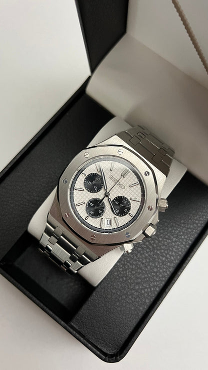 Royal Oak Chrono (Panda) Seiko VK63 meca-quartz chronograph mod watch. An angled shot of a watch with a white dial and black subdials resting inside a black display box.