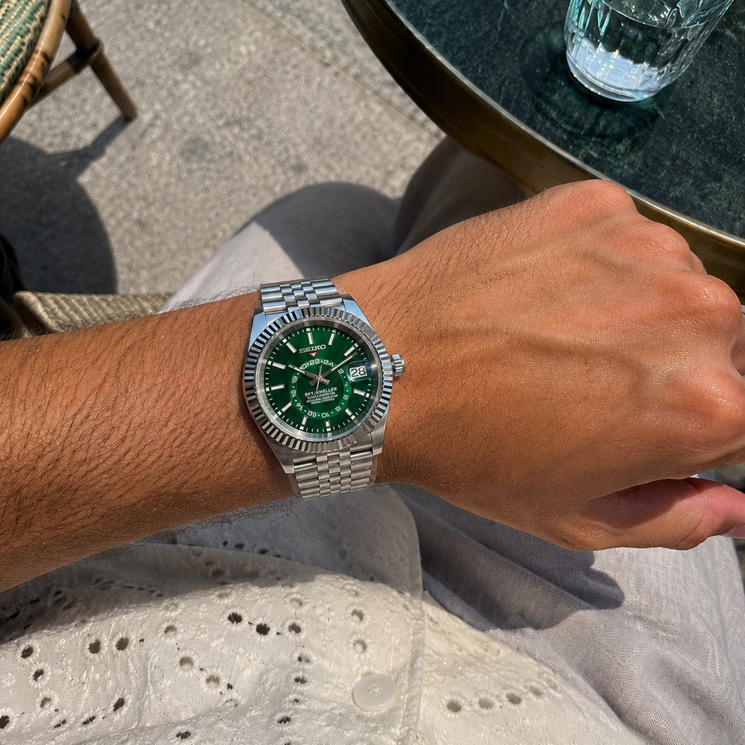 Submariner (Hulk) Seiko NH35 automatic mod watch. A wrist shot shows a green dial and silver fluted bezel on a silver metal jubilee bracelet.