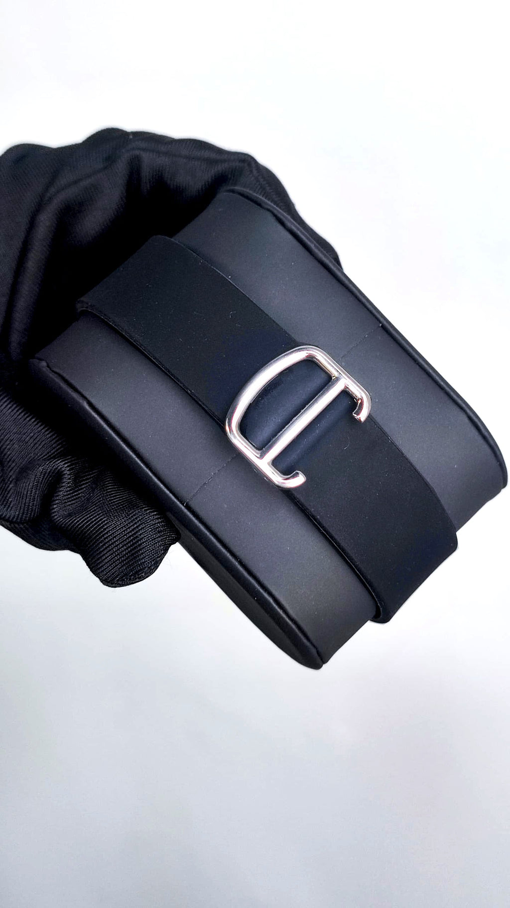Santos (Black) Seiko NH35 automatic mod watch. A clasp detail shot showing a silver buckle on a black rubber strap.