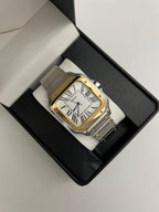 Santos (Two-Tone Gold) Seiko NH35 automatic mod watch. A watch in a box showing a white dial with a gold bezel and a silver and gold metal link bracelet.